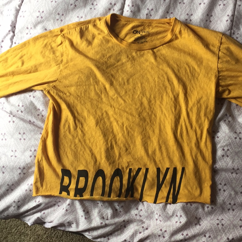 Slightly cropped, long sleeve, gold shirt